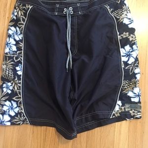 Black board shorts with aloha flower pattern